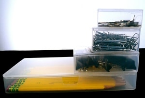 Plastic Boxes for office storage, filled with items.